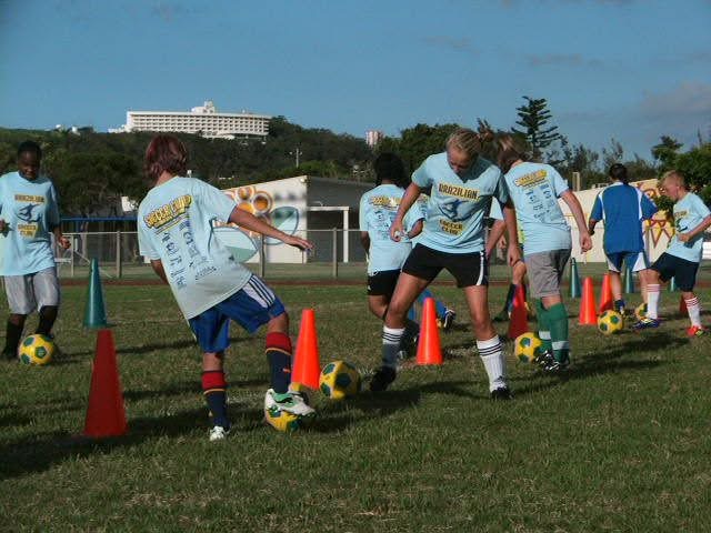 BSC Summer Camp 2011 — campers dribbling through cones on the field