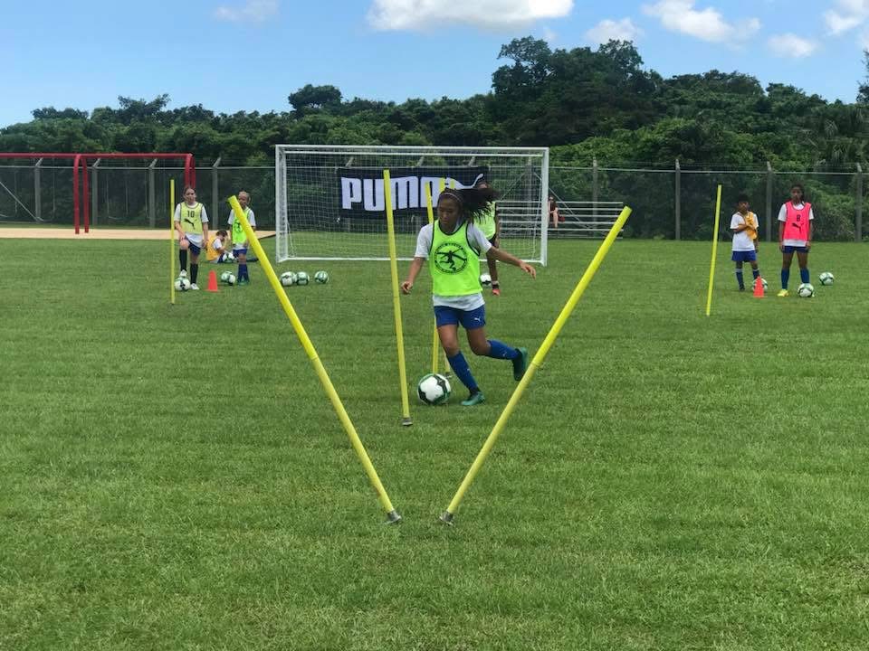 BSC Summer Camp 2017 — camper dribbling through poles on the field