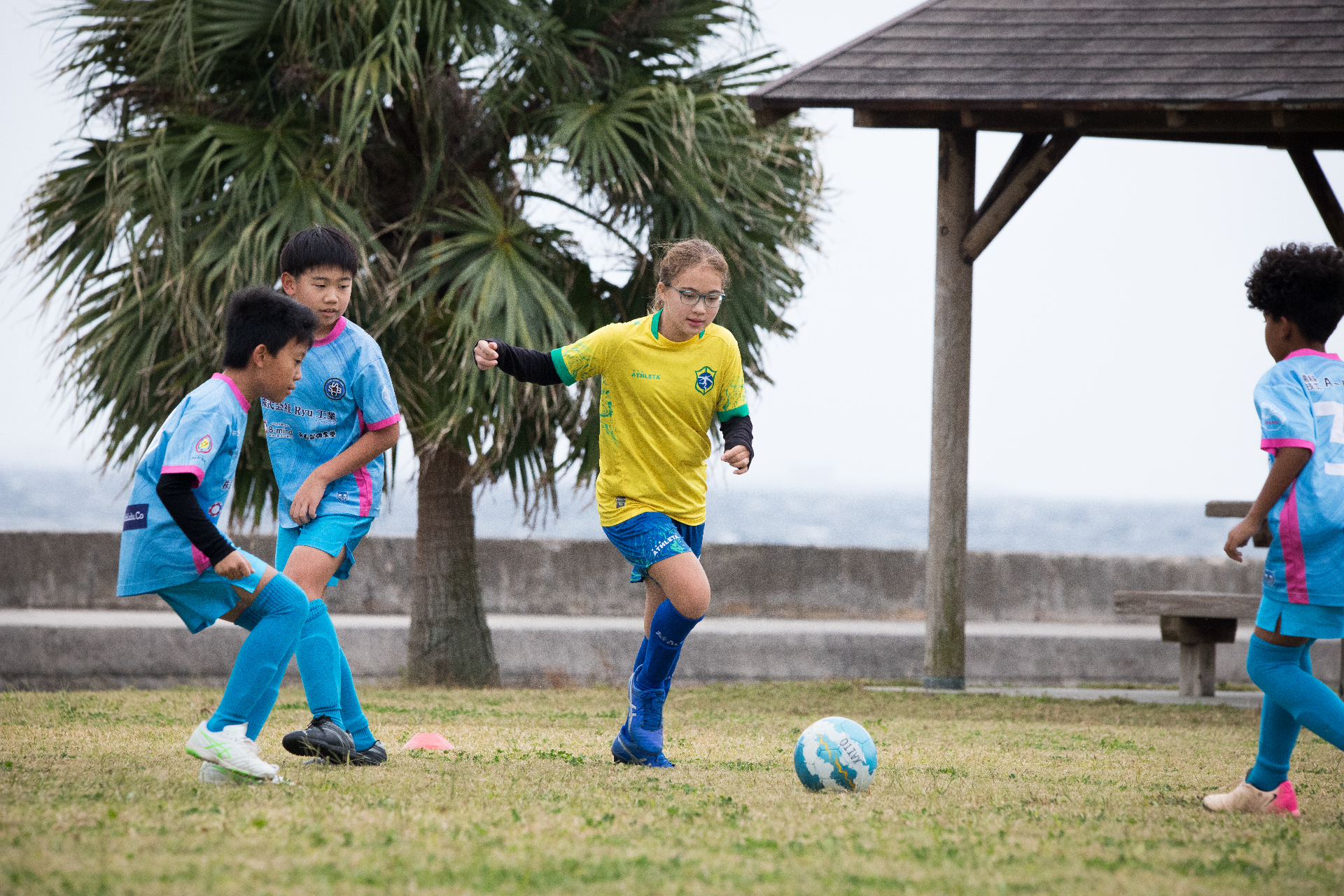 Coed BSC player dribbling by the sea in Okinawa