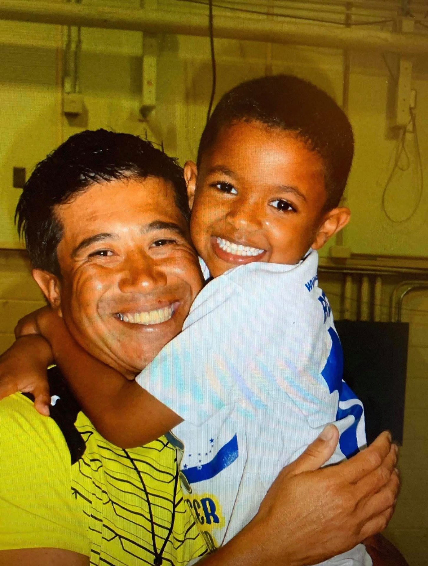 BSC coach and young camper sharing a smile together in Okinawa