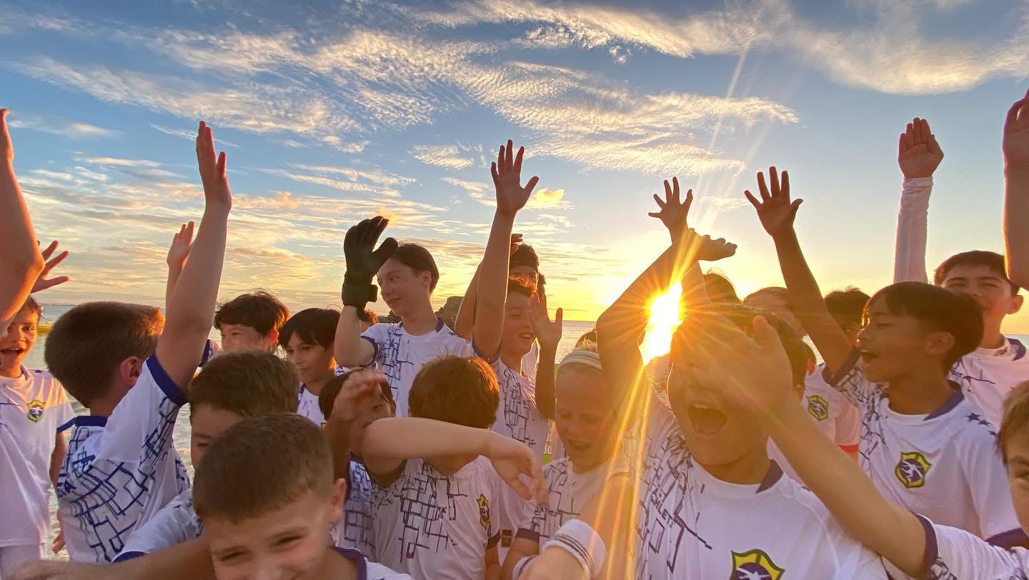 BSC campers celebrating together on the beach at sunset in Okinawa