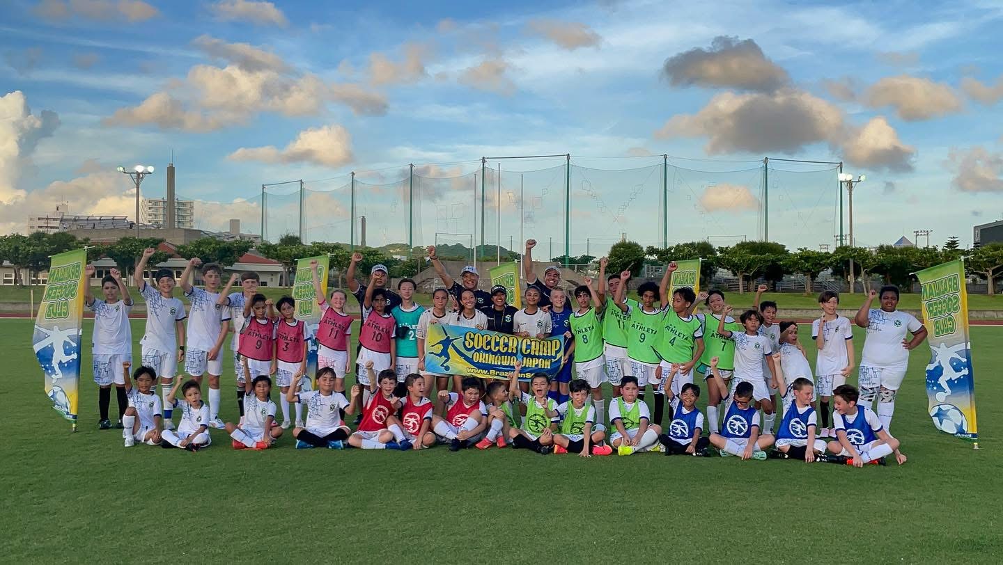 BSC Summer Camp 2024 — campers and coaches group photo on the field with banners