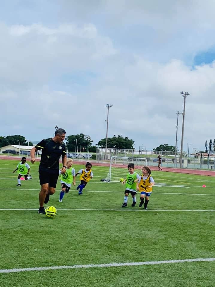 BSC Summer Camp 2020 — coach leading young campers in a drill on the field